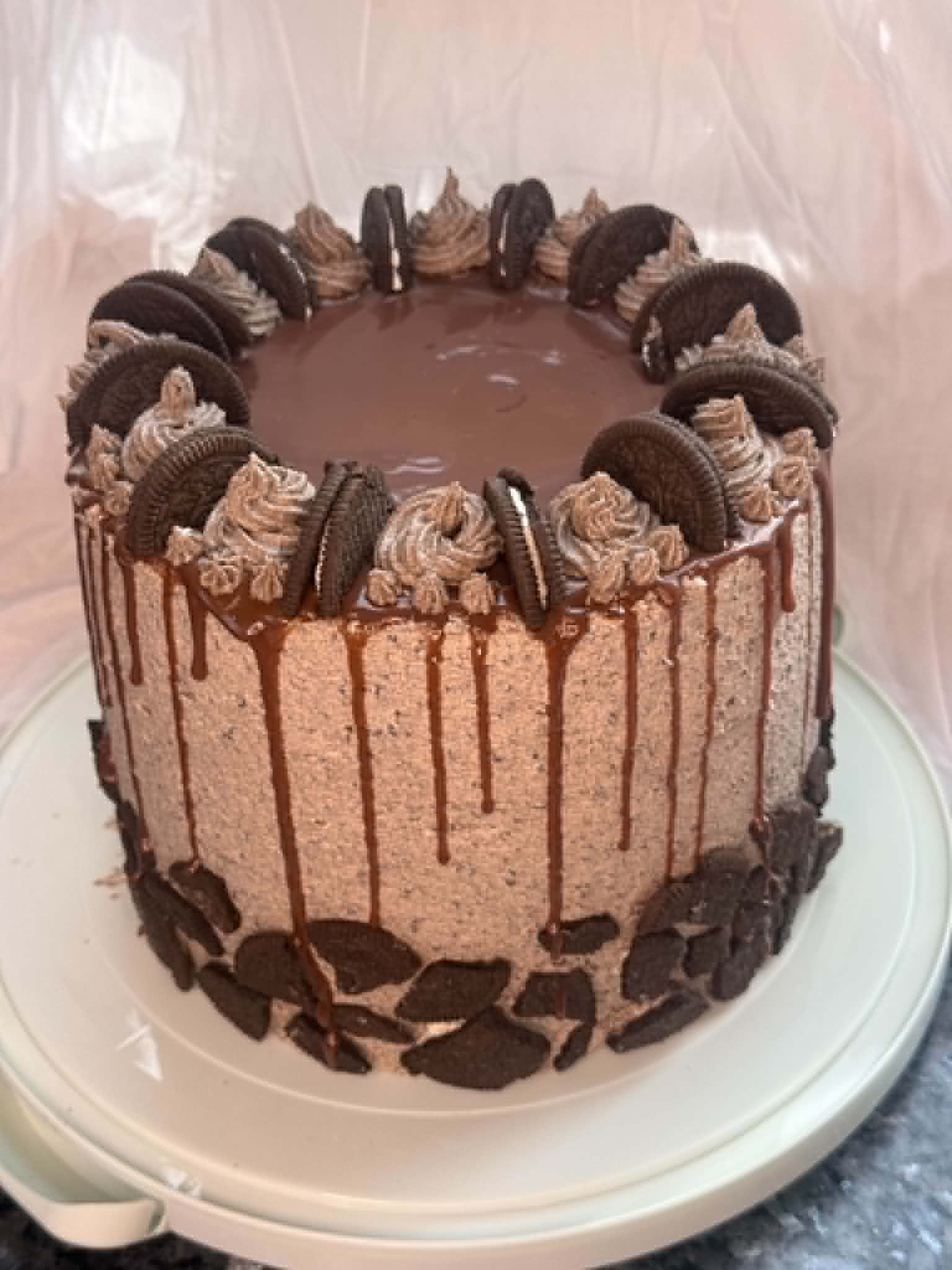 Chocolate drip cake decorated with Oreo cookies and piped chocolate buttercream