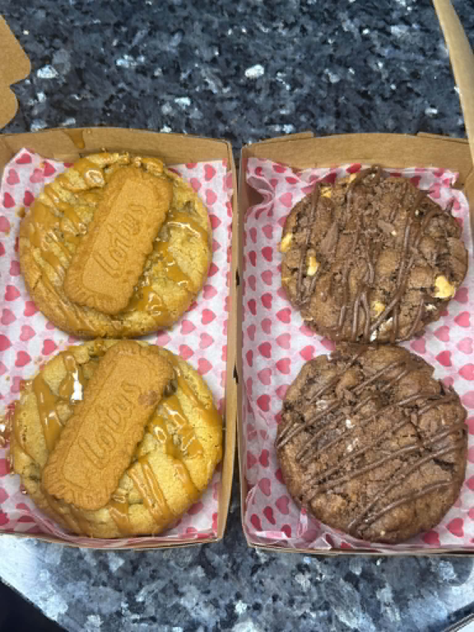 Two Biscoff stuffed cookies drizzled with caramel and topped with Biscoff biscuits